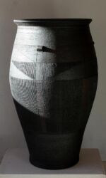 Large urn with finely scored geometric design. Bronze/black.
Height 75cm/30”.